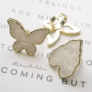 White pearlescent butterfly and heart palette rings with gold adjustable band