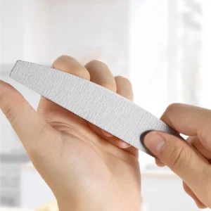 Hand holding thick curved nail file showing ergonomic grip