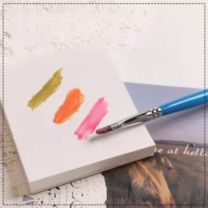 Disposable nail polish mixing paper with three gel swatches and brush