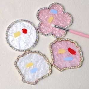 Gem-studded nail mixing palettes in flower and seashell shapes