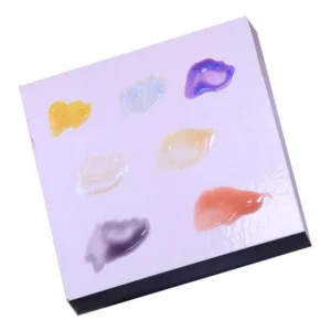 Close-up of multiple gel shades on glossy disposable palette