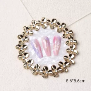Decorative round nail display tray with gold floral rim and white pearlescent center