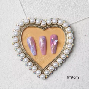 Heart-shaped nail display tray with pearl and gem border in vintage gold tone