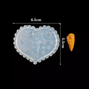 Clear heart-shaped mold with intricate floral and petal elements for nail crafting