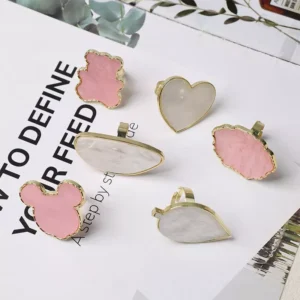 Gold-trimmed metal nail palettes with pearl and pink enamel in fun shapes