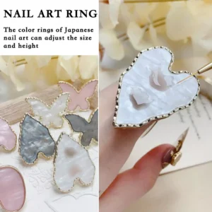 Pearlescent nail art ring in gold setting on display