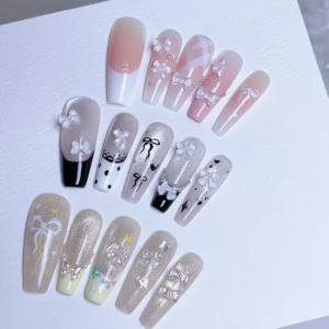 Clear resin mini bow nail charms applied to false nail tips