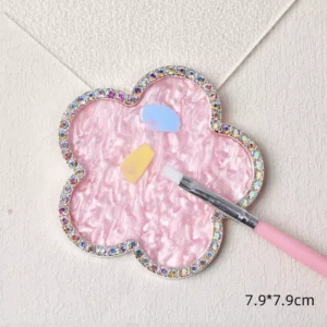 Pink flower-shaped nail palette with rhinestone rim and gel colors