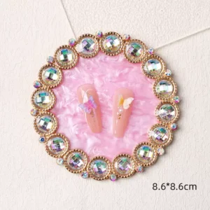 Round pink nail palette with gem-studded rim and pearlescent background