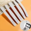 Set of thick 100/180 grit salon nail files in assorted shapes on orange background