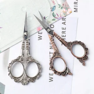 Close-up of silver and rose gold vintage manicure scissors