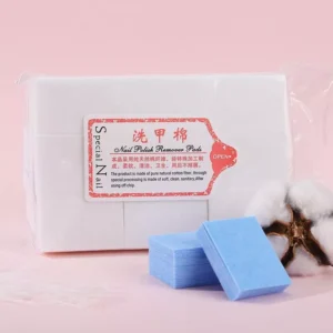 White nail polish remover pad pack with blue cotton pads beside cotton flower