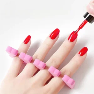 Pink heart toe separators in use during red nail polish application