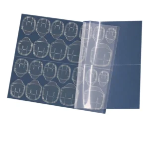 Transparent nail adhesive stickers on dark backing sheet