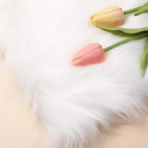 White soft faux fur nail photography background with tulip props
