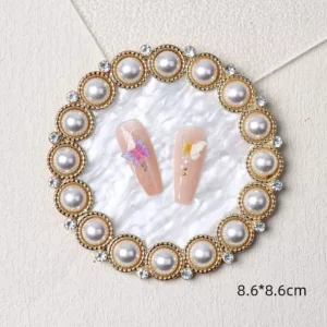 Round white pearl nail display tray with decorative edge and subtle gold detailing